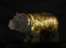 Work of art ''Hippopotamus'', a chocolate and gold sculpture by artist Santiago Montoya. The hippopotamus has his body covered in gold. From the exhibition at Espacio El Dorado ''Missteps and other paths''.