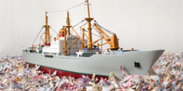 Work of art ''Maquette for a dream - ship'' by artist Santiago Montoya, made of shredded currency. It is a ship floating on a sea made of shredded currency.