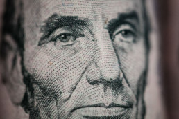 Close-up on Abraham Lincoln's face on 5$ bill, one of the paper money used by artist Santiago Montoya.